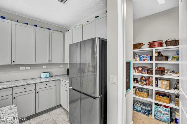 a kitchen with stainless steel appliances white cabinets and a window
