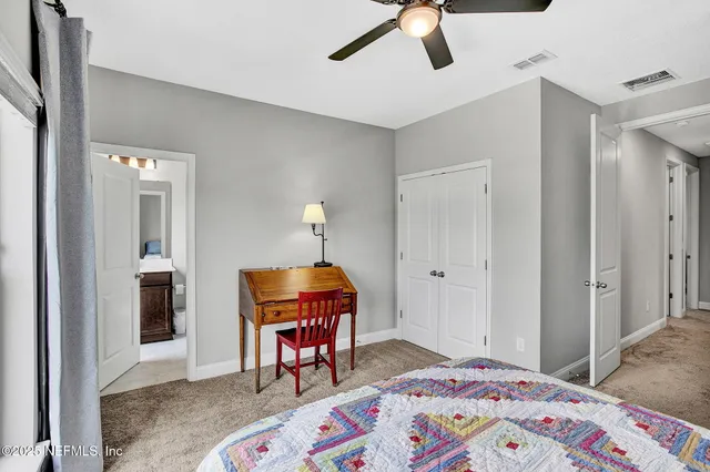 a bedroom with furniture and a window