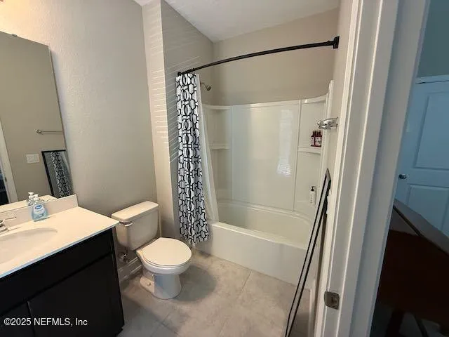 a bathroom with a sink a toilet a mirror and shower