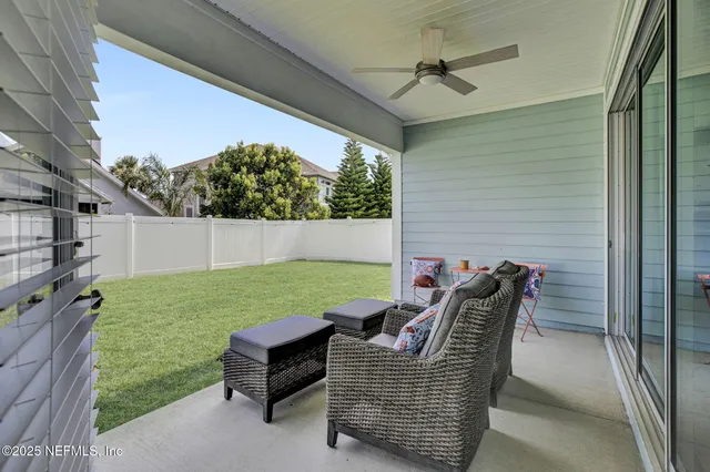 a backyard of a house with table and chairs