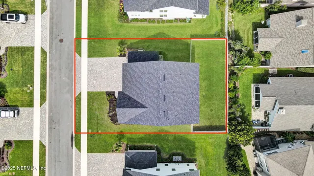 an aerial view of a house with a yard basket ball court and outdoor seating