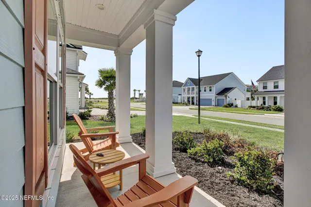 a view of a chairs and table in the balcony