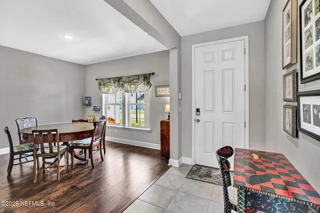 a dining room with furniture and wooden floor