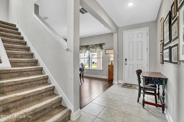 a view of entryway and hall with wooden floor
