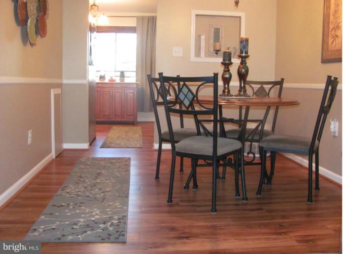 7952 Tick Neck Road Pasadena, MD 21122 - Photo 1 of 27 a view of a dining room with furniture and wooden floor