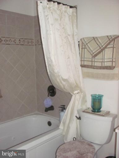 7952 Tick Neck Road Pasadena, MD 21122 - Photo 14 of 27 a bathroom with a bathtub and toilet