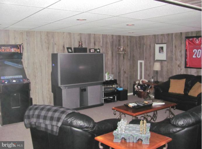 7952 Tick Neck Road Pasadena, MD 21122 - Photo 15 of 27 a living room with furniture a dining table and a piano