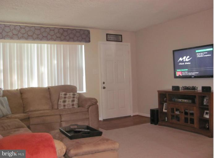 7952 Tick Neck Road Pasadena, MD 21122 - Photo 18 of 27 a living room with furniture and a flat screen tv