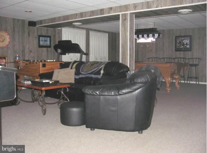 7952 Tick Neck Road Pasadena, MD 21122 - Photo 21 of 27 a living room with furniture and a table