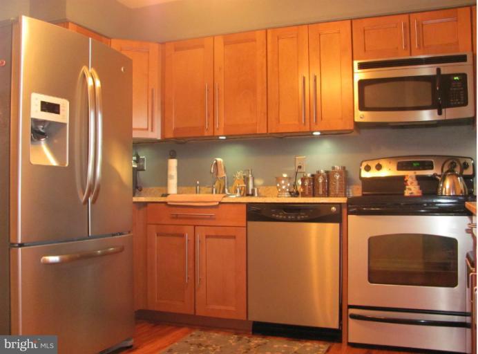 7952 Tick Neck Road Pasadena, MD 21122 - Photo 5 of 27 a kitchen with stainless steel appliances granite countertop a refrigerator a stove a sink and dishwasher