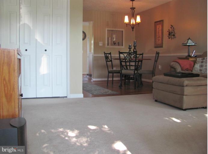 7952 Tick Neck Road Pasadena, MD 21122 - Photo 8 of 27 a view of a livingroom with furniture and a chandelier