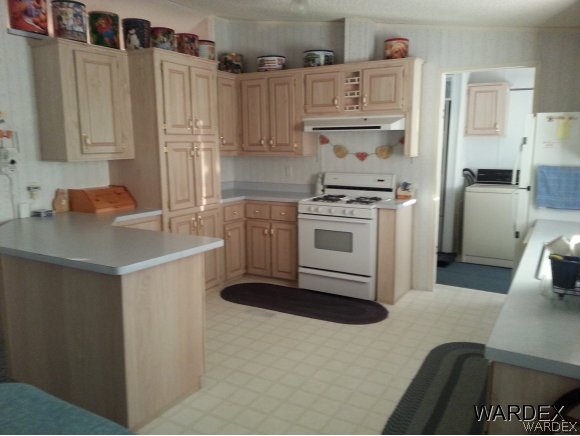3500 Tooman Road Golden Valley, AZ 86413 - Photo 3 of 7 a kitchen with cabinets and appliances