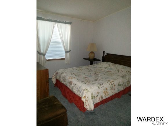 3500 Tooman Road Golden Valley, AZ 86413 - Photo 7 of 7 a bedroom with a bed and a window