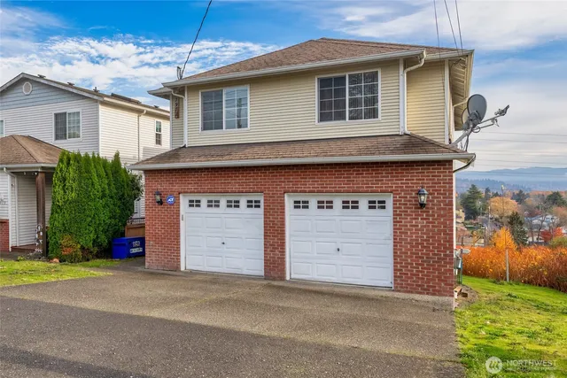 a front view of a house with a yard and garage