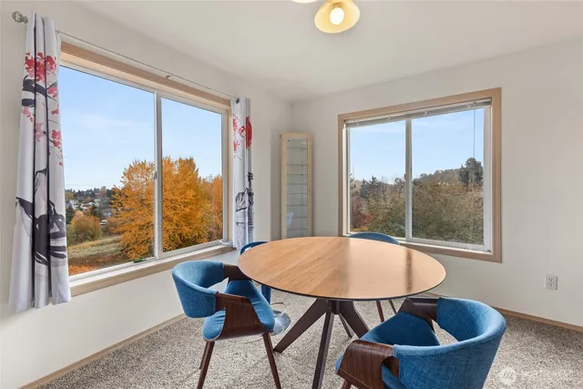 a kitchen with refrigerator and white cabinets