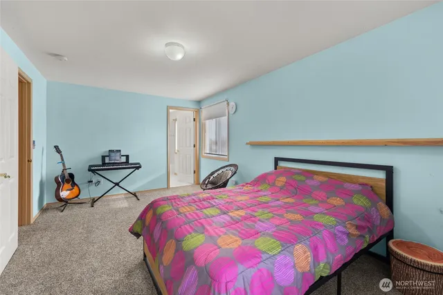 a bedroom with a bed and a couch