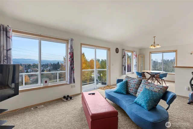 a bed room with furniture and a flat screen tv