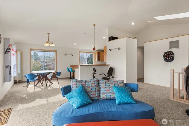 a kitchen with stainless steel appliances kitchen island granite countertop a table and chairs in it