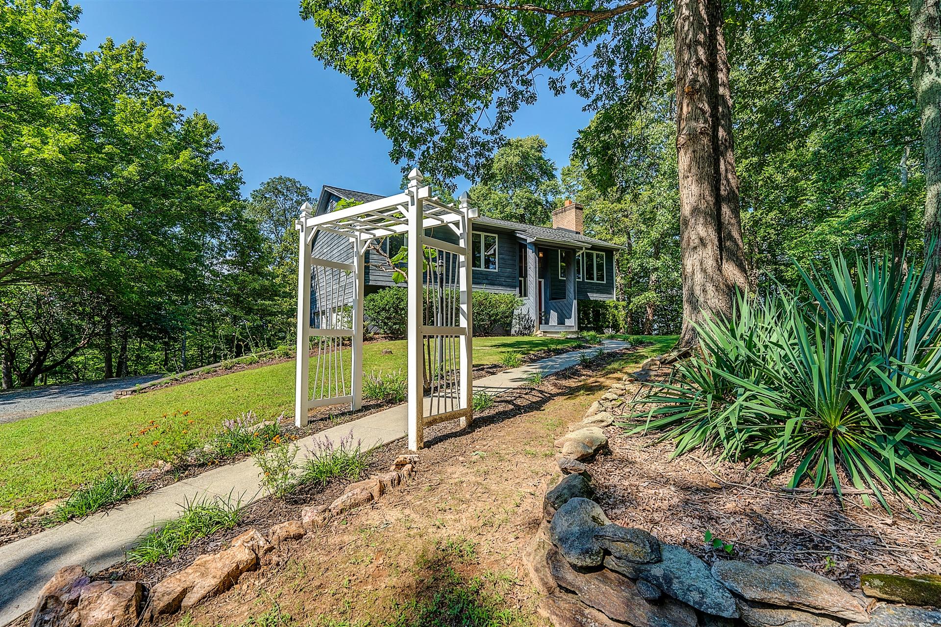 935 Altice Mill Road Rocky Mount, VA 24151 - Photo 2 of 34 a view of a wooden house with a big yard and potted plants