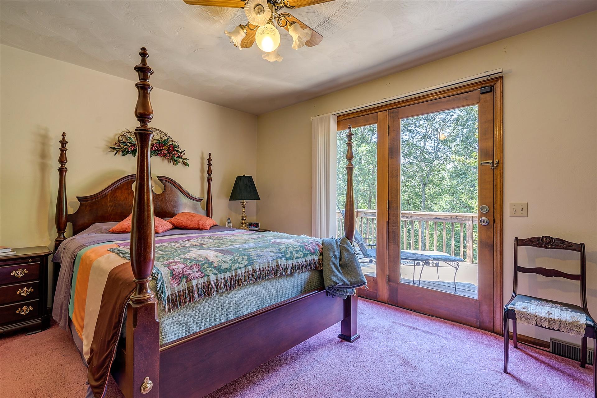 935 Altice Mill Road Rocky Mount, VA 24151 - Photo 25 of 34 a bedroom with a bed and a chandelier