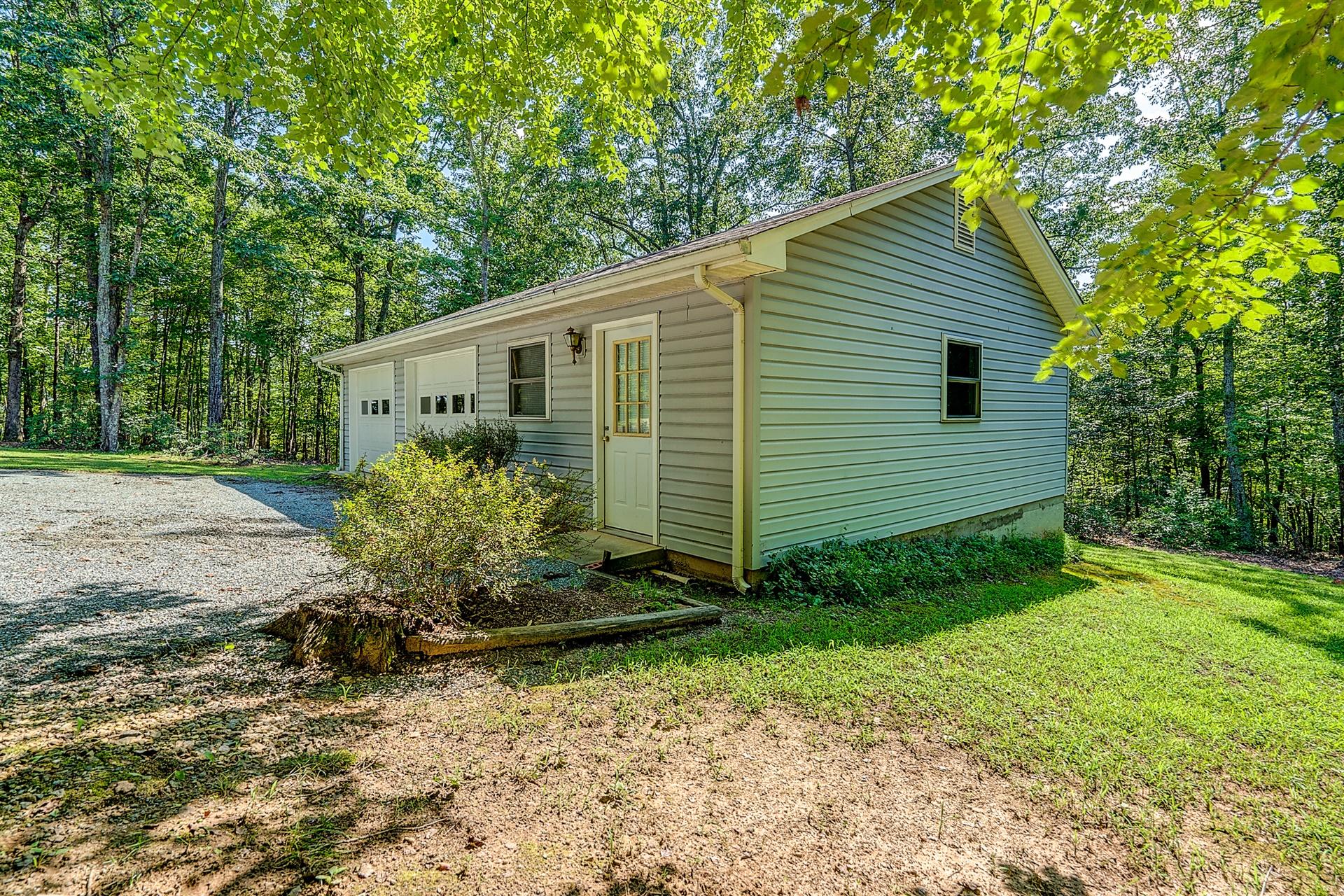935 Altice Mill Road Rocky Mount, VA 24151 - Photo 8 of 34 a backyard of a house with plants and outdoor seating
