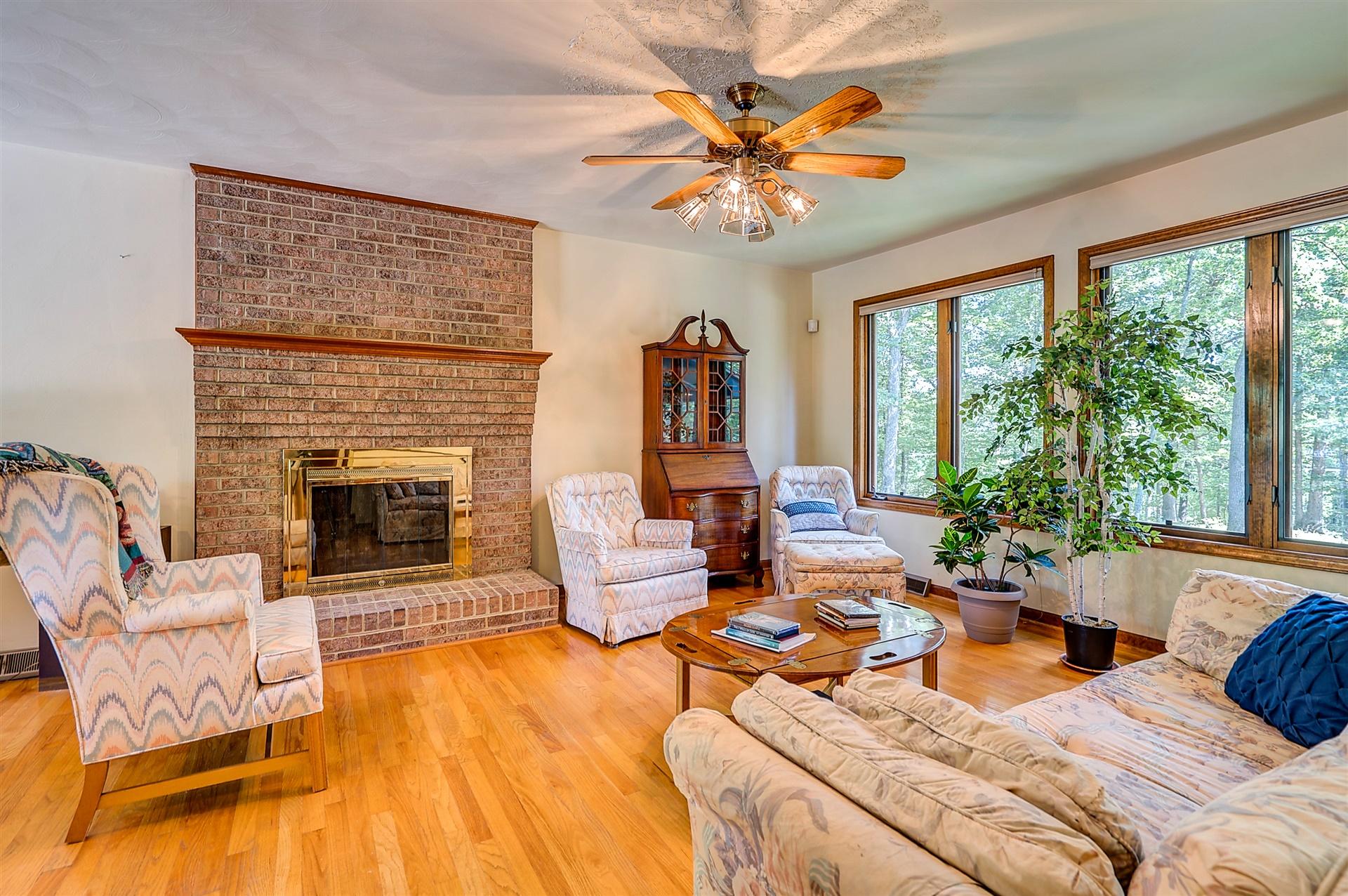 935 Altice Mill Road Rocky Mount, VA 24151 - Photo 9 of 34 a living room with patio furniture and a fireplace