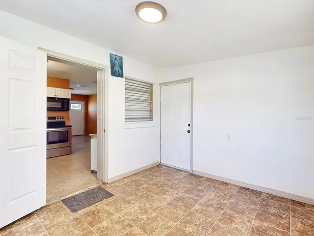 an empty room with closet and a rug
