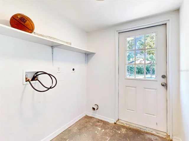 a front view of a house with white walls and a window