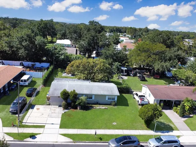 an aerial view of a house with a yard