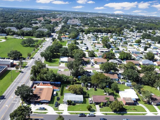 a aerial view of a house with a yard and sitting area