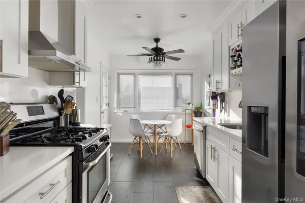 a kitchen with stainless steel appliances a stove a sink and a refrigerator