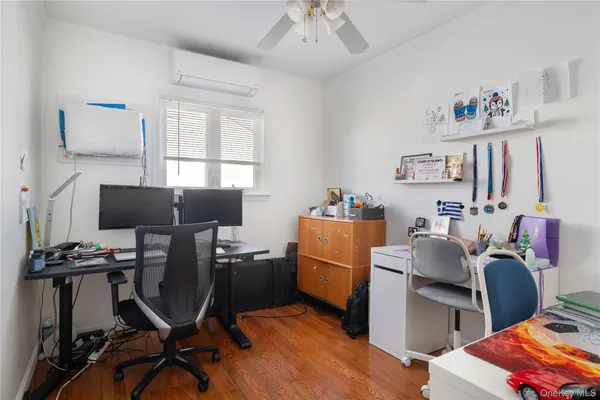 a view of a workspace with furniture and a window
