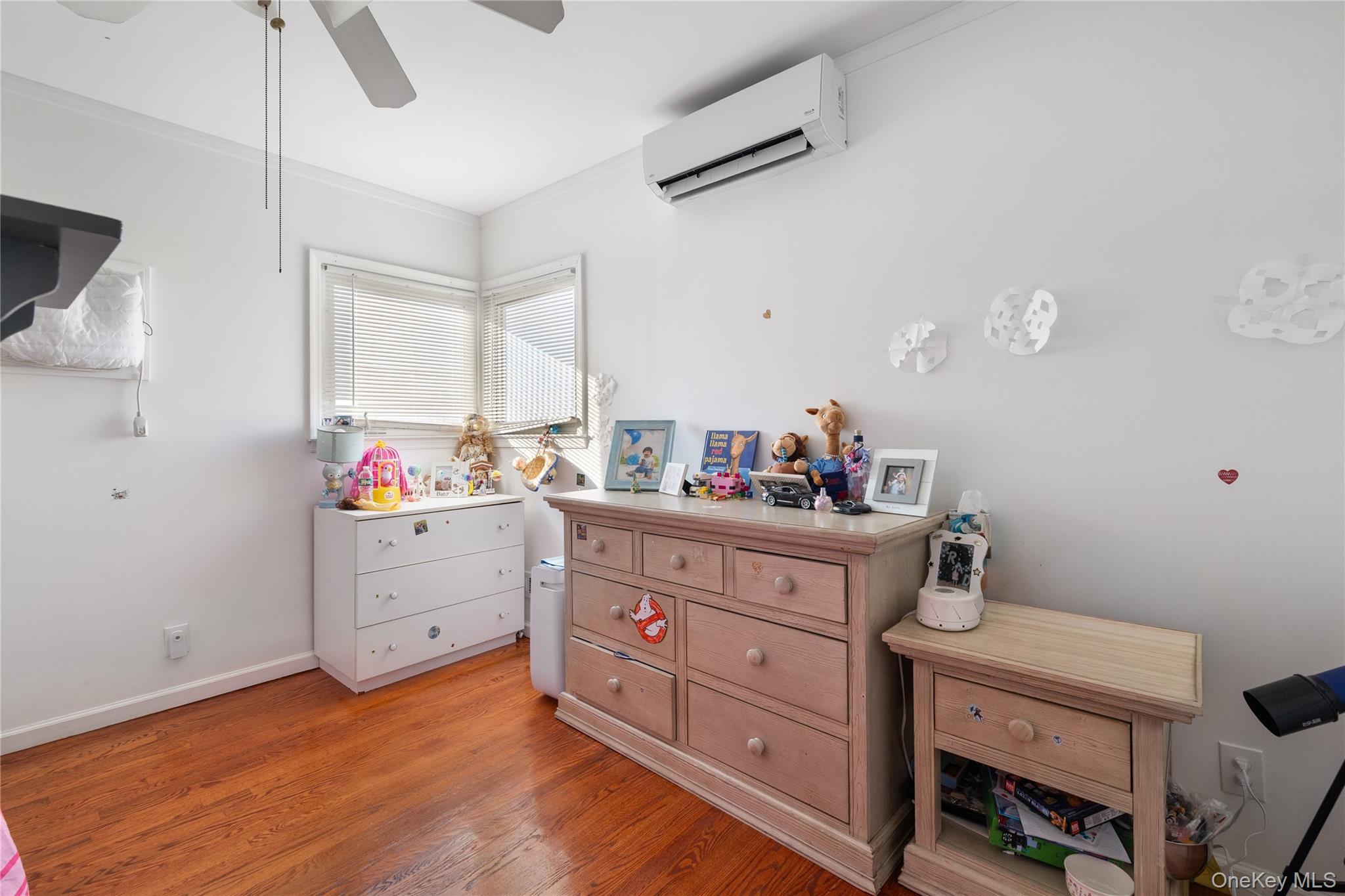 13-52 145th Place Queens, NY 11357 - Photo 15 of 25 a room with a baby crib furniture and a dresser