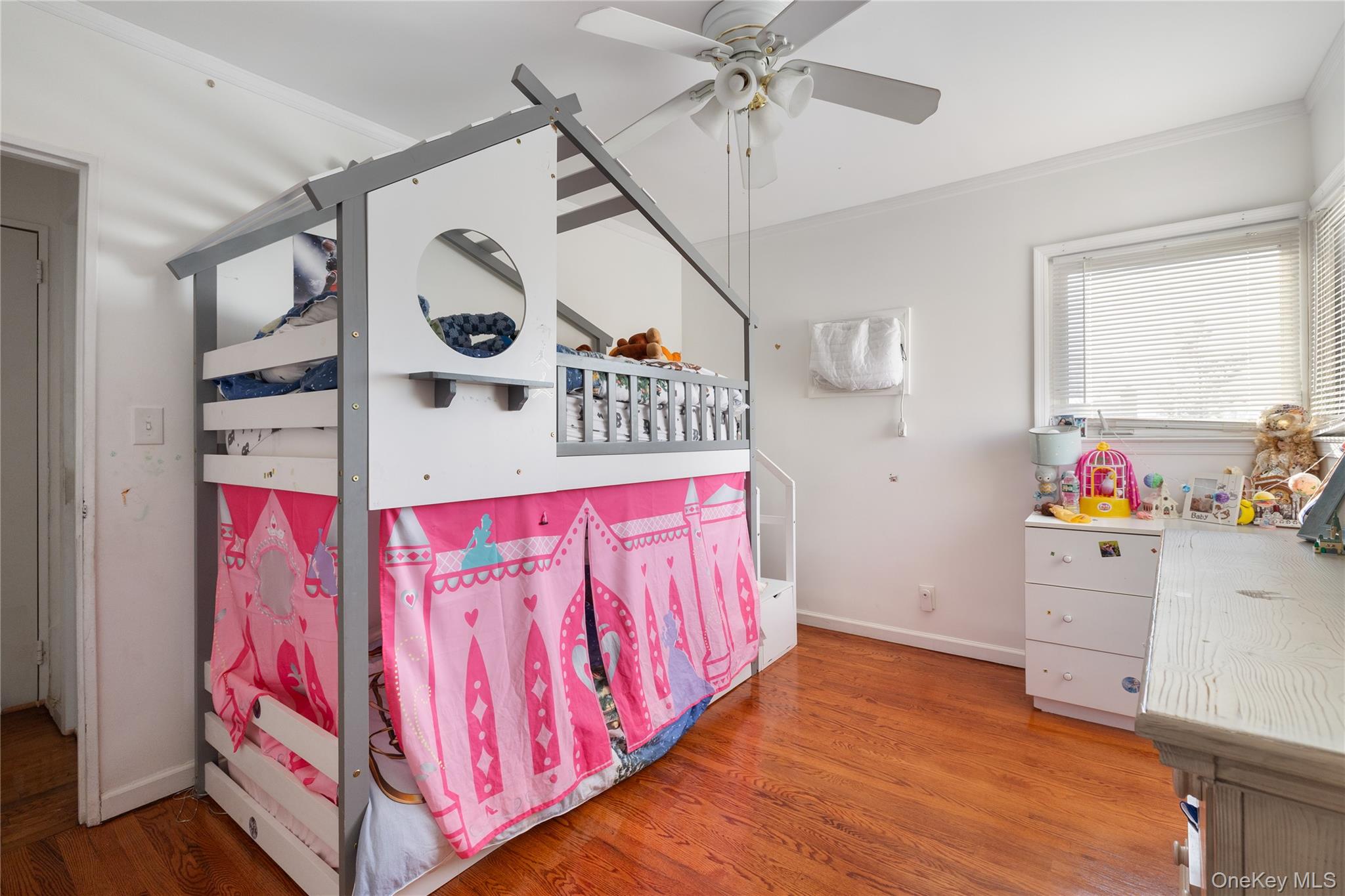 13-52 145th Place Queens, NY 11357 - Photo 16 of 25 a very nice looking room with wooden floor and fan