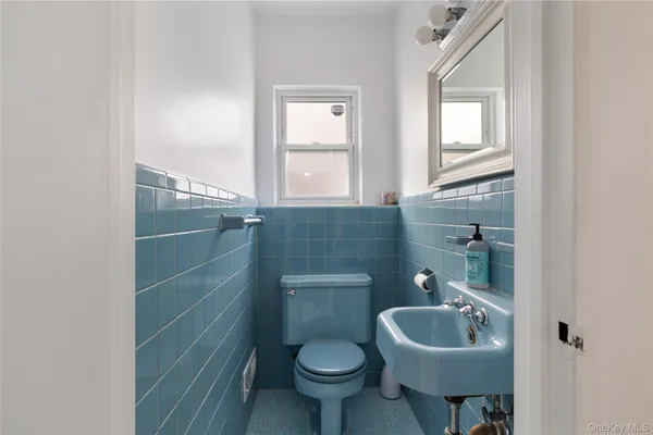 a bathroom with a sink a toilet and a mirror