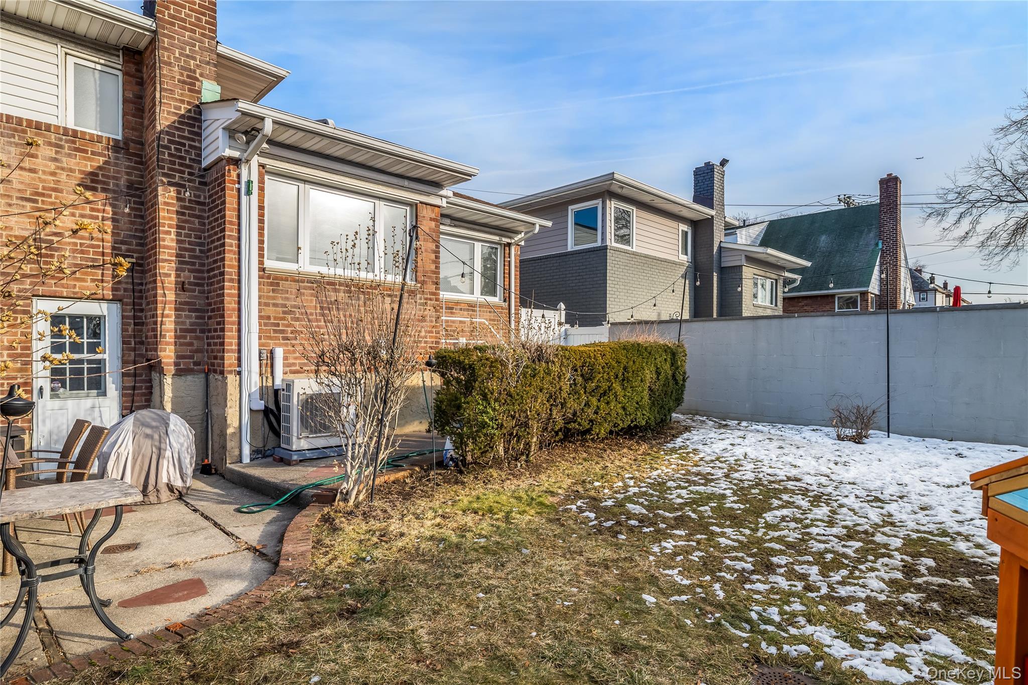 13-52 145th Place Queens, NY 11357 - Photo 22 of 25 a backyard of a house with table and chairs