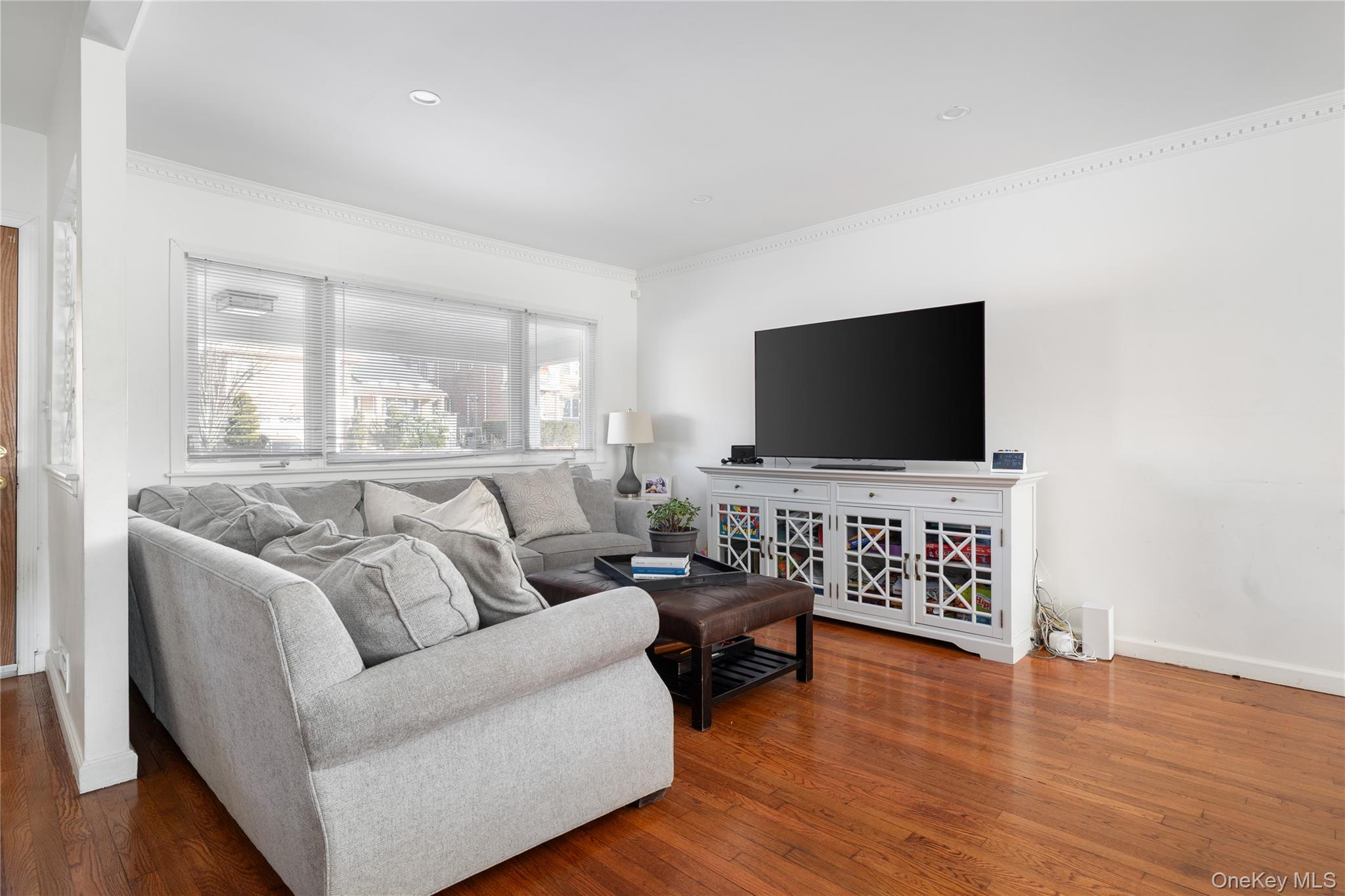 13-52 145th Place Queens, NY 11357 - Photo 5 of 25 a living room with furniture and a flat screen tv