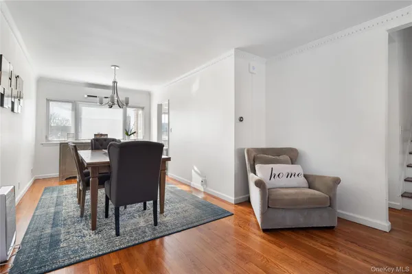 a dining room with furniture and wooden floor