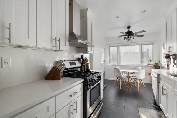 a kitchen with stove cabinets and window
