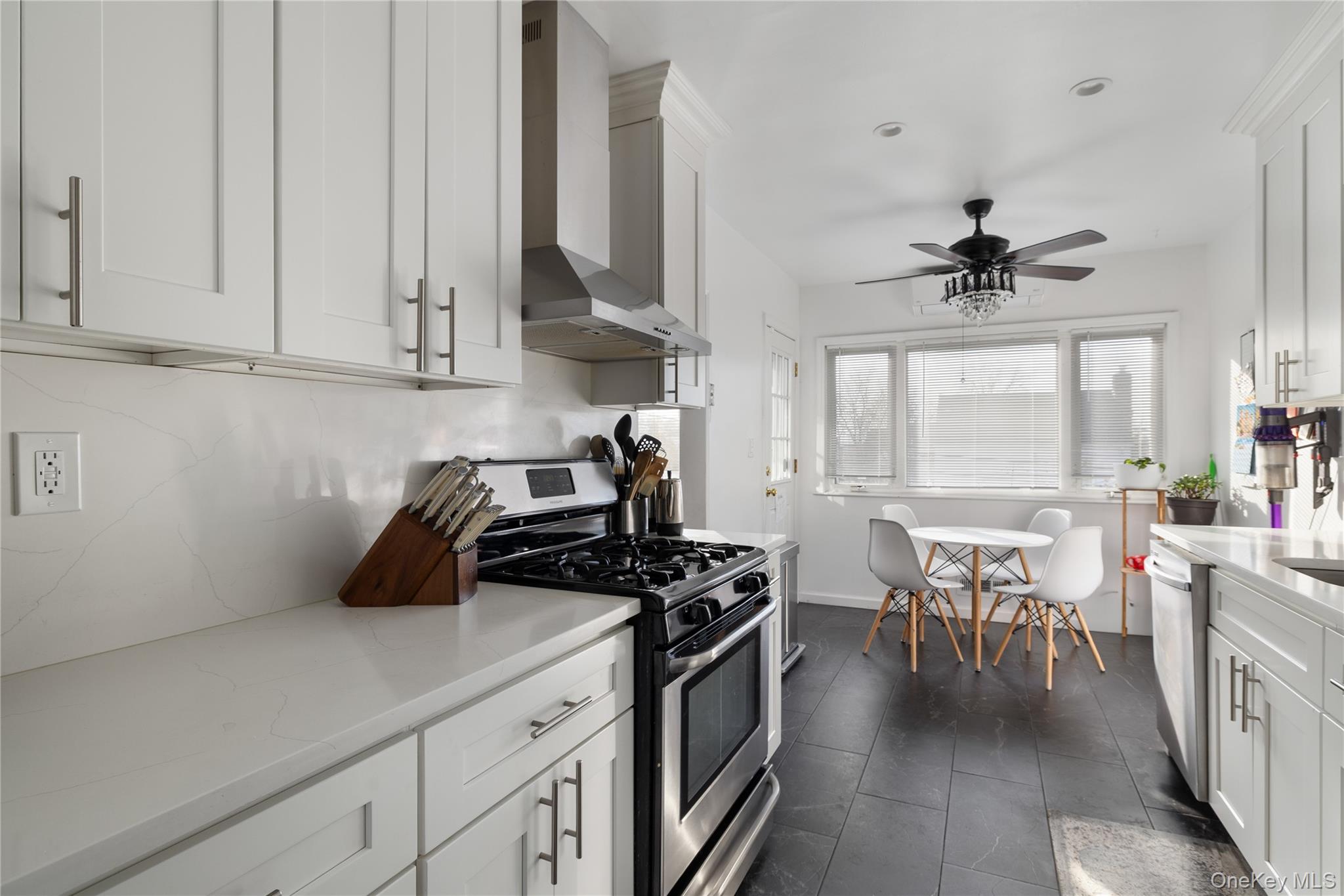 13-52 145th Place Queens, NY 11357 - Photo 8 of 25 a kitchen with stove cabinets and window