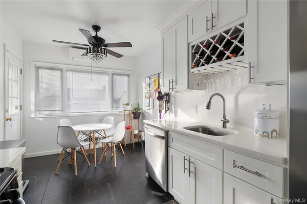 a kitchen with stainless steel appliances a table and chairs