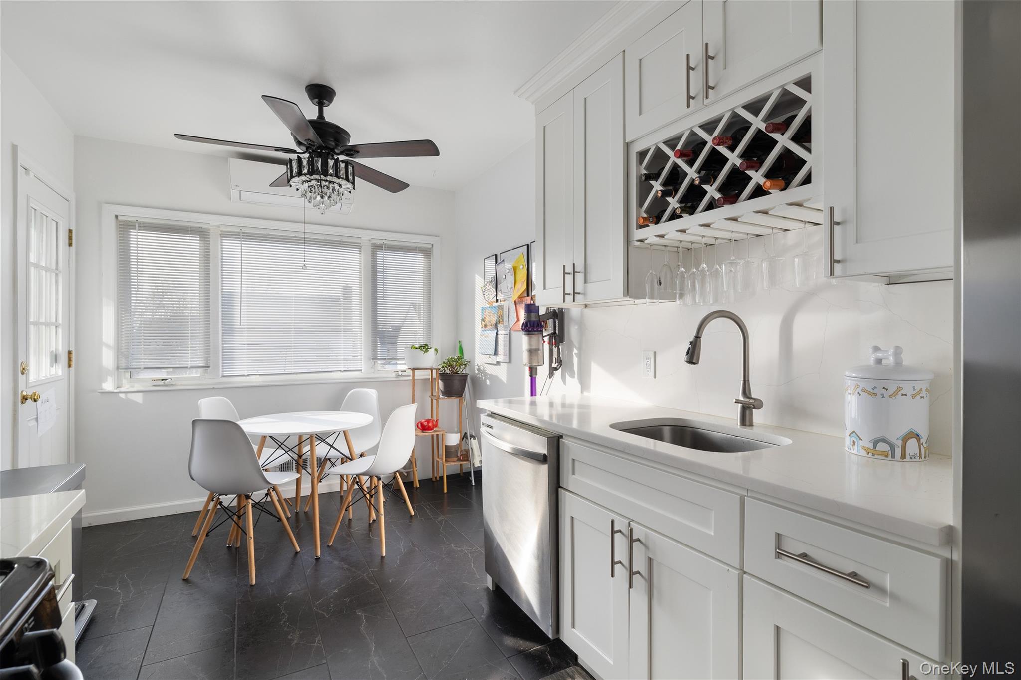 13-52 145th Place Queens, NY 11357 - Photo 9 of 25 a kitchen with stainless steel appliances a table and chairs