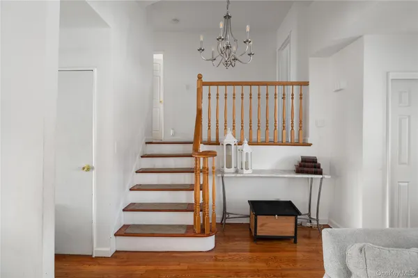 a view of entryway and hall with wooden floor