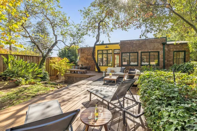 a view of a patio with table and chairs and potted plants