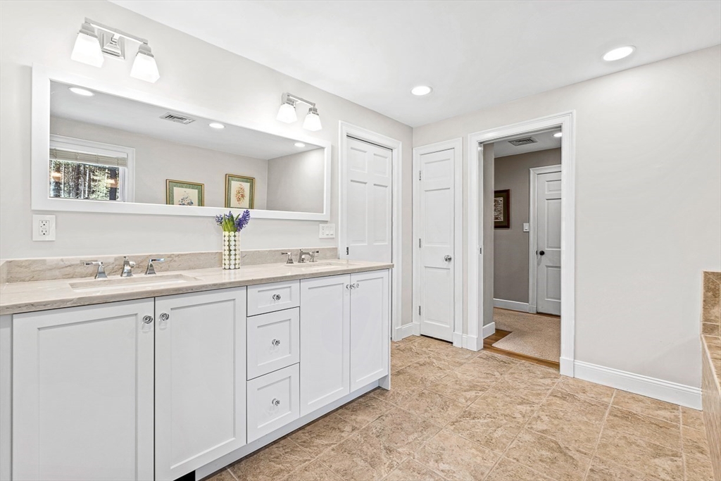 359 Grove Street Needham, MA 02492 - Photo 23 of 37 a spacious bathroom with a granite countertop sink and mirror