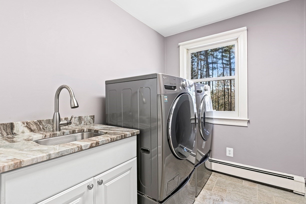 359 Grove Street Needham, MA 02492 - Photo 27 of 37 a bathroom with a sink and a mirror