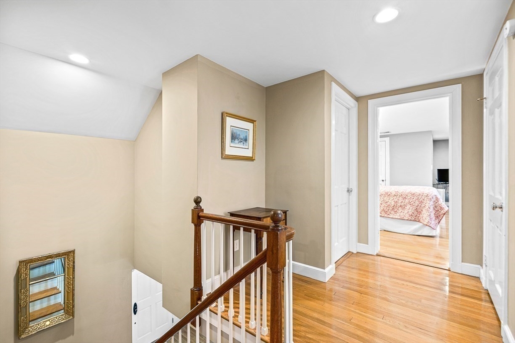 359 Grove Street Needham, MA 02492 - Photo 28 of 37 a view of a hallway with bedroom and wooden floor