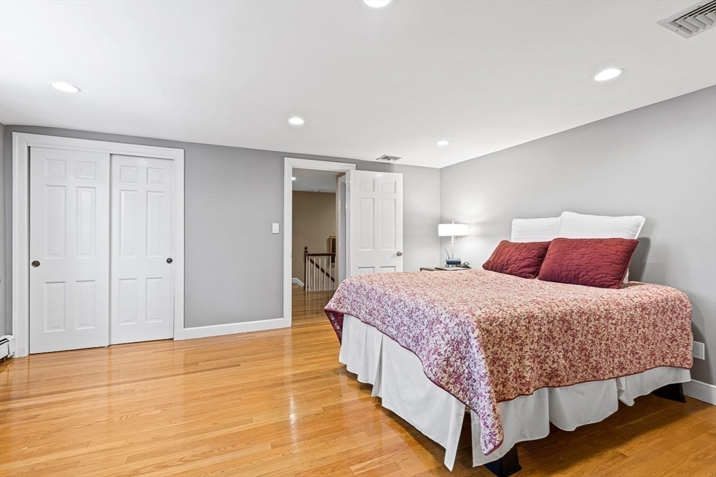 359 Grove Street Needham, MA 02492 - Photo 29 of 37 a bedroom with a large bed and a wooden floor
