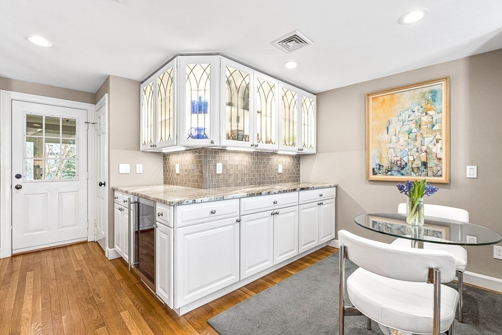 359 Grove Street Needham, MA 02492 - Photo 10 of 37 a kitchen with granite countertop white cabinets and white appliances