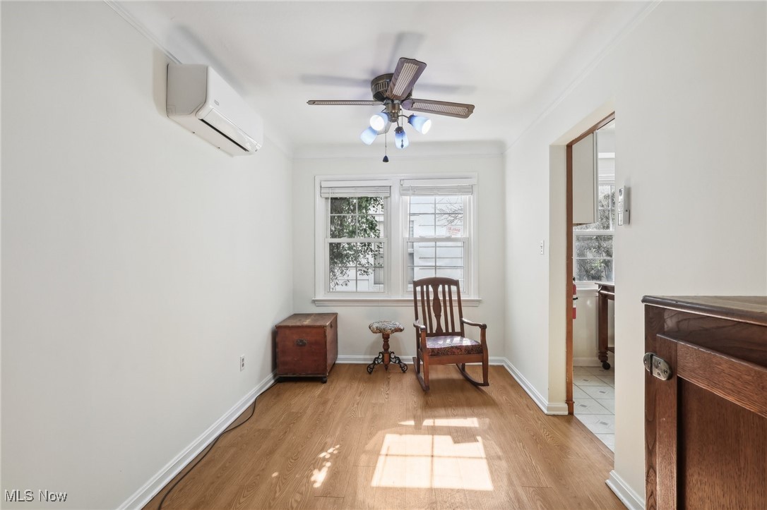 1042 Renfield Road Cleveland Heights, OH 44121 - Photo 14 of 49 Sitting room featuring ceiling fan, ornamental molding, light wood-type flooring, and a wall mounted air conditioner